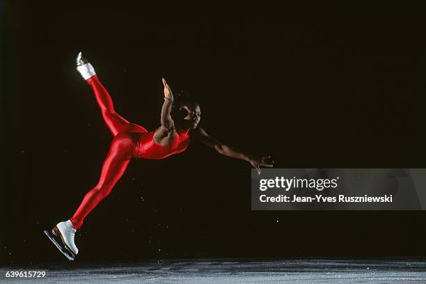 Surya Bonaly performing on ice during an exclusive photo shoot.