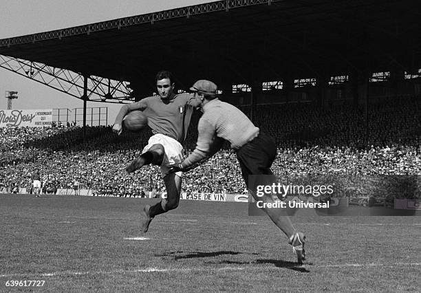 Carlo Galli of Italy and France's goalkeeper Rene Vignal during an international match between France and Italy .