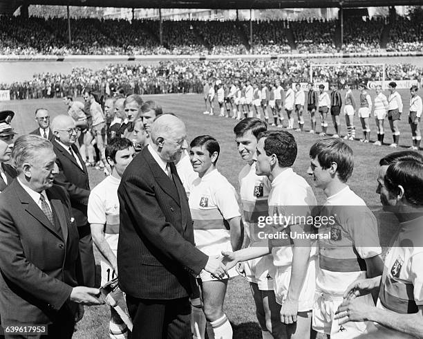 French President General Charles de Gaulle shakes hands to Lyon's player Robert Nouzaret before the French Cup Final, Lyon vs Sochaux .