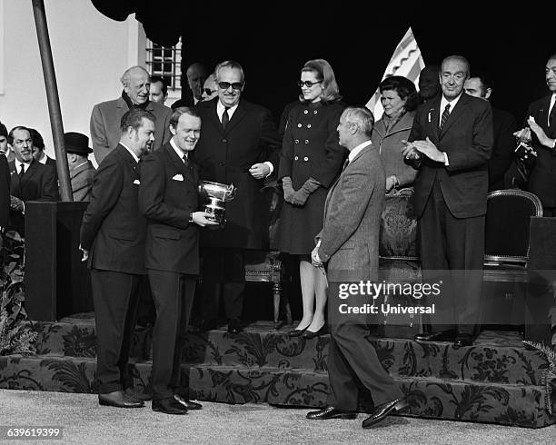 Bjorn Waldegard, winner of the 1970 Monte-Carlo receives his trophy from Prince Rainier and Princess Grace of Monaco.