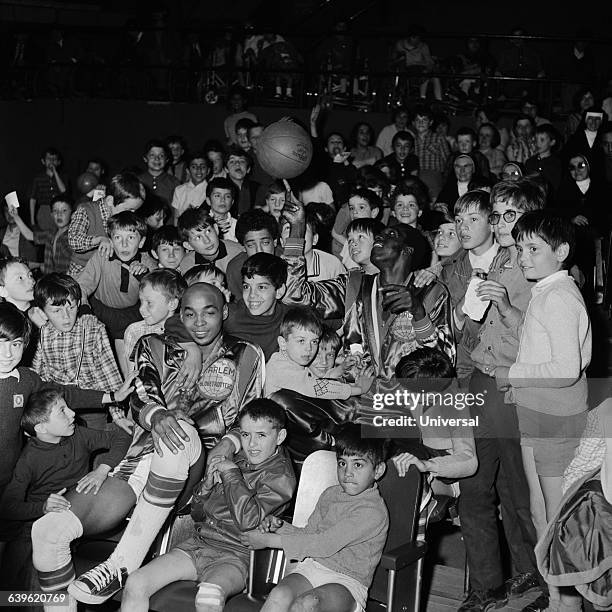 Freddie Neal and Meadowlark Lemon of the Harlem Globetrotters in Paris with young fans.