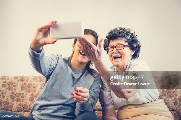 two generations together, smiling and taking selfie - oost europese cultuur stockfoto's en -beelden