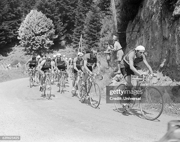 Bicyclists round a corner in the 10th stage of the 1951 Tour de France. Fausto Coppi leads the group, followed by Hugo Koblet. | Location: Between...