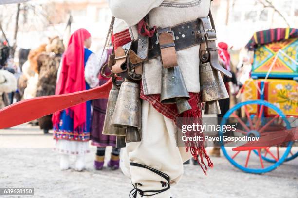 masquerade participant wearing heavy traditional bells and costume during a traditional kukeri festival - bulgarians stock pictures, royalty-free photos & images