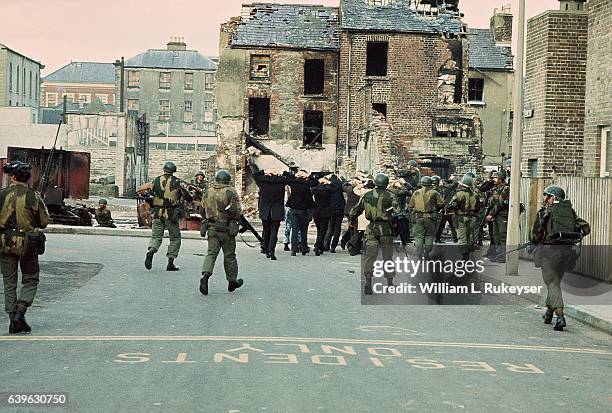 Arrested civilians are marched towards detention in the Bogside Area of Londonderry by British troops on Bloody Sunday 30th January 1972