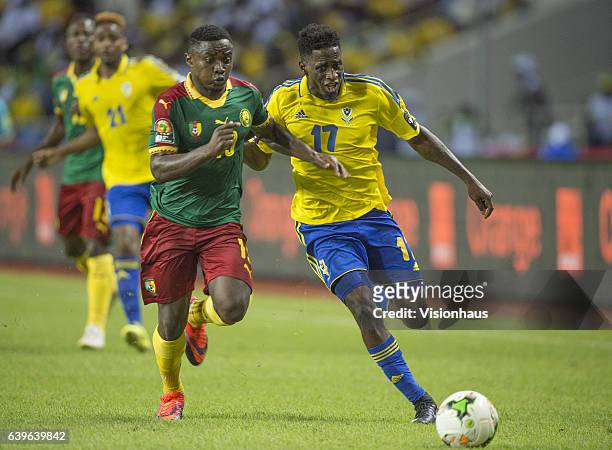 Of Cameroon and ANDRE BIYOGO POKO of Gabon during the Group A match between Cameroon and Gabon at Stade de L'Amitie on January 22, 2017 in...