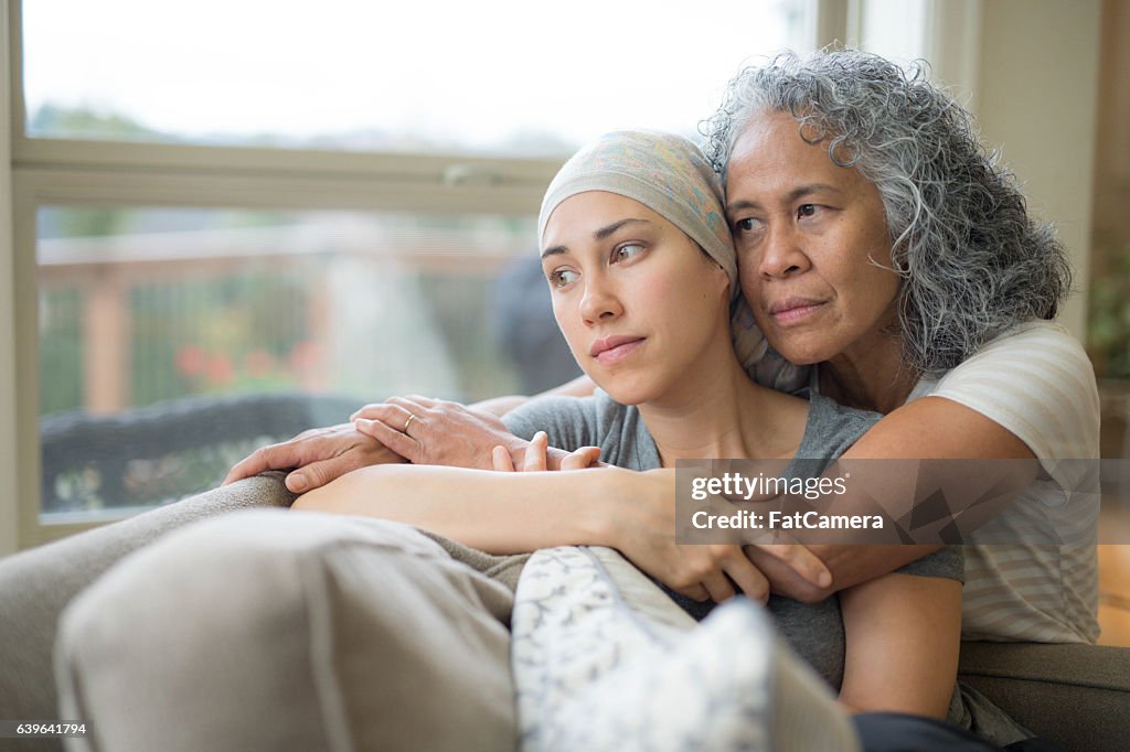 Adult female with cancer being nurtured by her mature mother