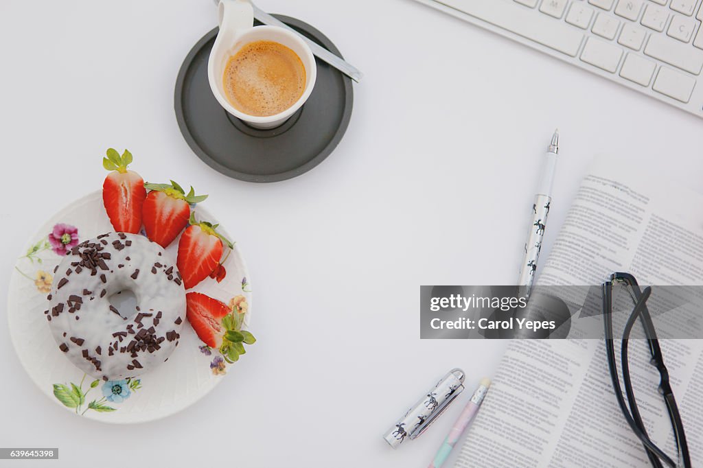 Overhead laptop studio desk with morning breakfast