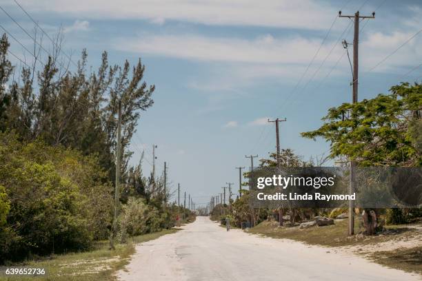 a deserted road where a single man walks - san salvador stock pictures, royalty-free photos & images