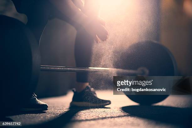 preparing to lift dumbell in a gym - cross training stock pictures, royalty-free photos & images