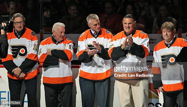 Don Saleski, Terry Crisp, Paul Holmgren, Ed Hospodar and Darren Jensen of the Philadelphia Flyers Alumni stand in front of the bench during the...