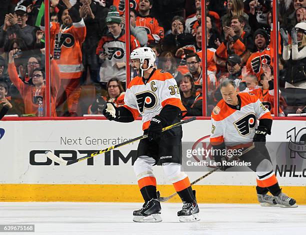 Eric Desjardins of the Philadelphia Flyers Alumni celebrates his third period goal with teammate Reggie Leach against the Pittsburgh Penguins Alumni...