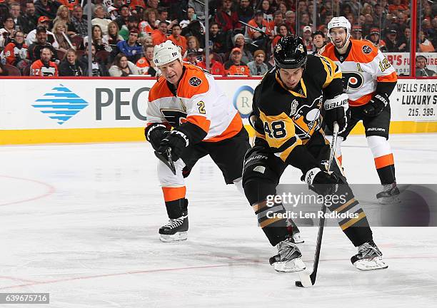 Tyler Kennedy of the Pittsburgh Penguins Alumni skates the puck against Mark Howe and Simon Gagne of the Philadelphia Flyers Alumni on January 14,...