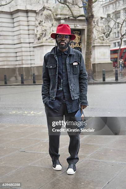 Fashion stylist Charley Van Purpz wears Kite glasses, Max Samon and Mary hat, Levi's clutch bag, Y3 trainers and River Island Tourne de Transmission...