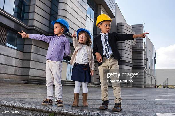 each direction is a good direction! - boy in hard hat stock pictures, royalty-free photos & images