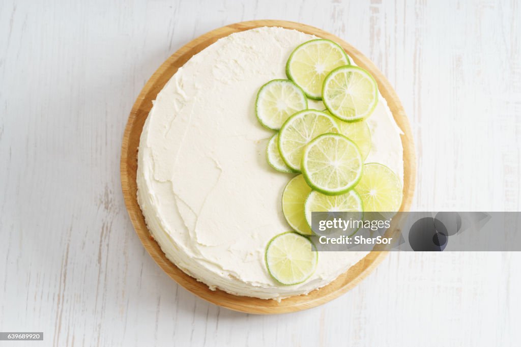 Sweet white buttercream cake with sliced lime on top