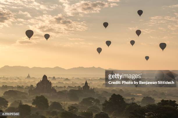 hot-air balloons flying over pagodas in bagan, mandalay, myanmar - bagan temples damaged in myanmar earthquake stock pictures, royalty-free photos & images