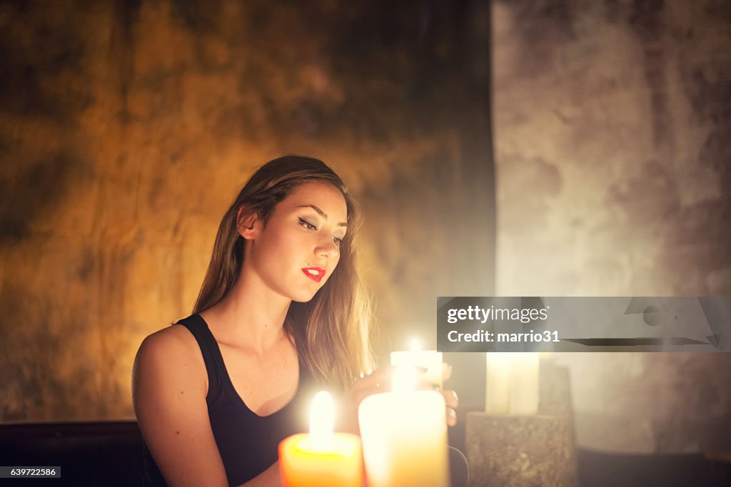 Beautiful witch making the witchcraft