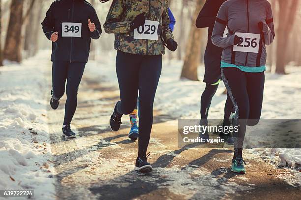 marathon runners. - winter running stock pictures, royalty-free photos & images