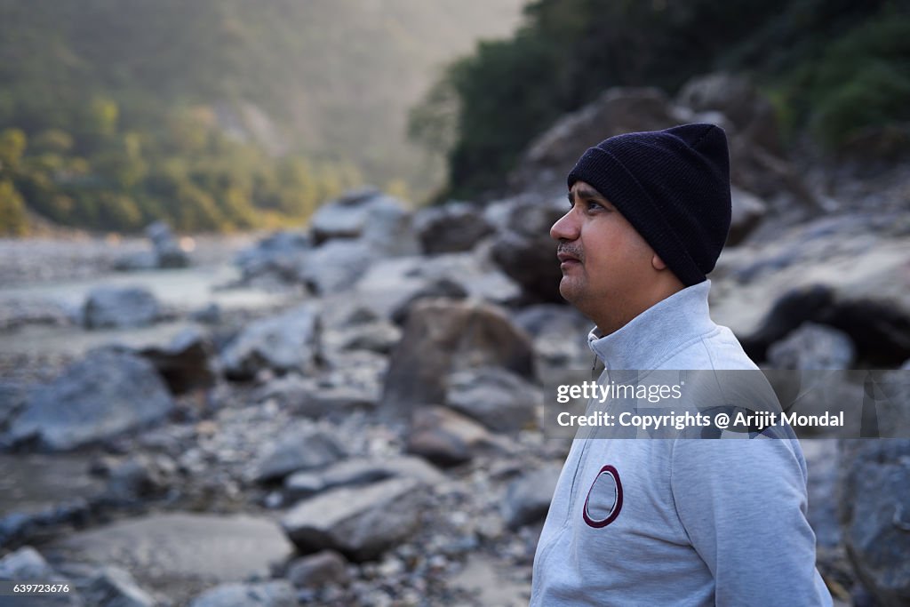 Relaxed Middle Age Man Looking at Distance at Himalaya Mountains, Rishikesh