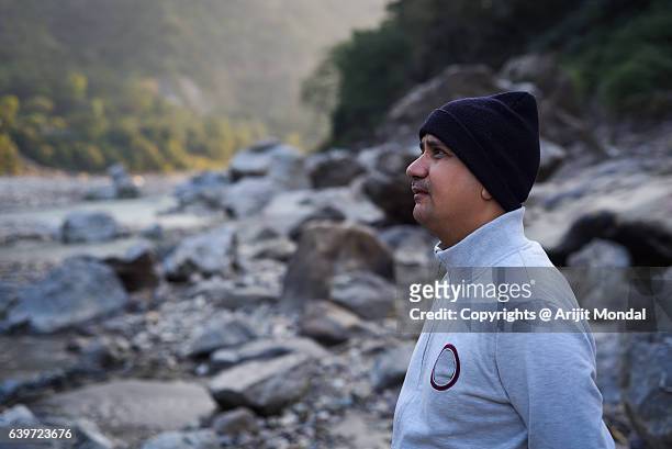 relaxed middle age man looking at distance at himalaya mountains, rishikesh - rishikesh meditation stock pictures, royalty-free photos & images