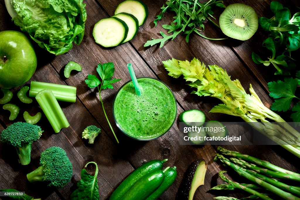 Detox diet concept: green vegetables on wooden table