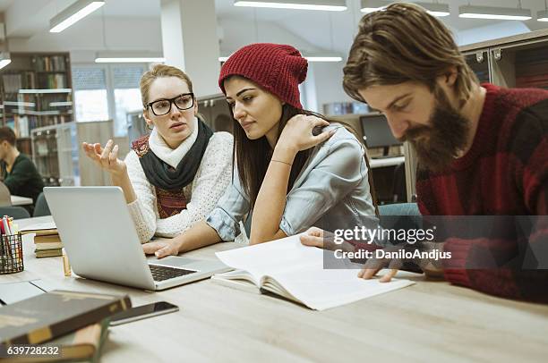 group of students researching togheter for their project - togheter stock pictures, royalty-free photos & images