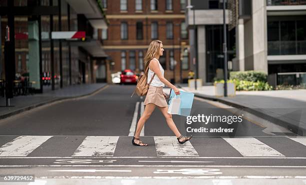 shopping woman crossing the street - australia shopping stockfoto's en -beelden