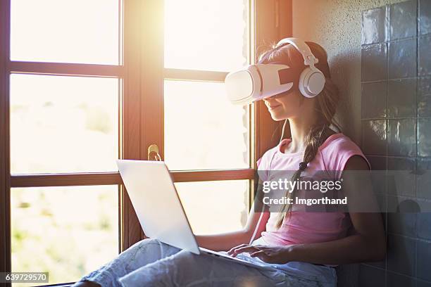 teenage girl using virtual reality headset - the new school stock pictures, royalty-free photos & images