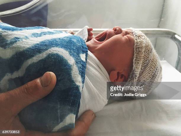 Fathers hands holding newborn baby