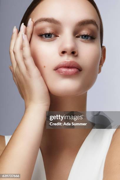 beauty cosmetic shot of a beautiful young woman touching her face - beauty treatment face stock pictures, royalty-free photos & images