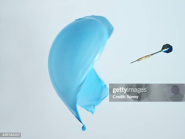 dart arrow explodes ballon - balloon burst stock pictures, royalty-free photos & images