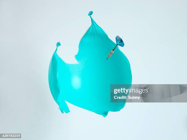 dart arrow explodes ballon - balloon burst stock pictures, royalty-free photos & images