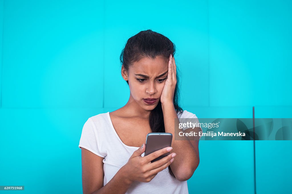 Young woman receive bad text message