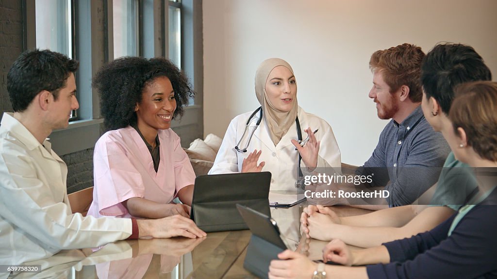 Confident Muslim Doctor Meets with Healthcare Professionals