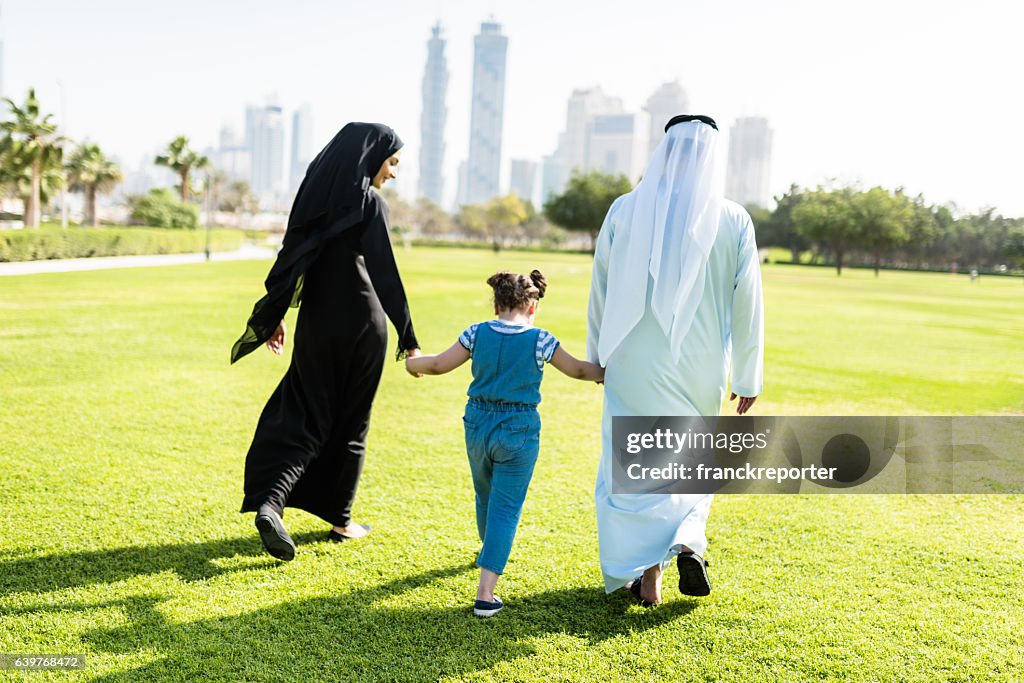 Happiness family walking in the park in dubai