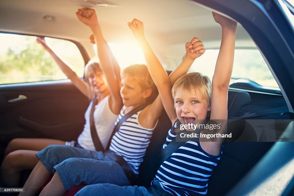 Kids having fun in car on a road trip