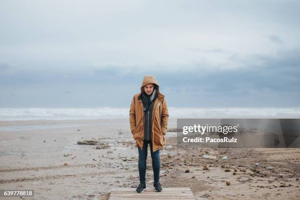 man with storm behind - long coat stock pictures, royalty-free photos & images