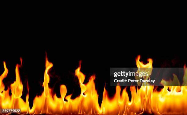 flames against black background - fire imagens e fotografias de stock