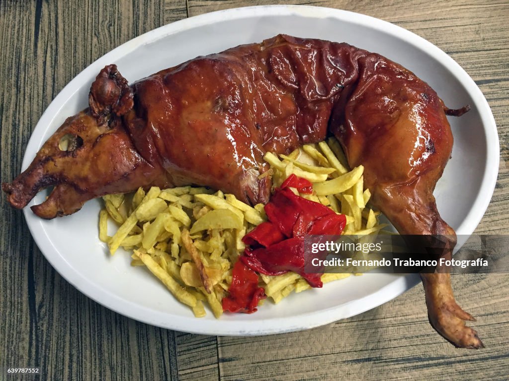 Roasted pig with chips and peppers