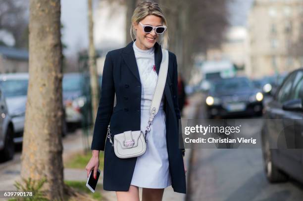 Sofie Valkiers wearing white Dior dress, bag, navy blazer jacket, white ankle boots outside Dior on January 23, 2017 in Paris, Canada.