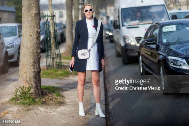 Sofie Valkiers wearing white Dior dress, bag, navy blazer jacket, white ankle boots outside Dior on January 23, 2017 in Paris, Canada.