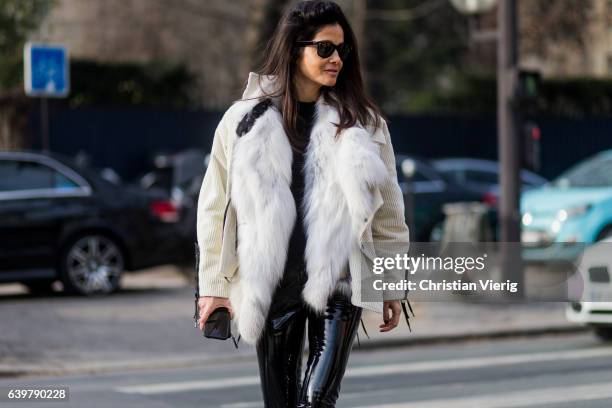 Barbara Martelo wearing a white fur jacket and PVC pants outside Dior on January 23, 2017 in Paris, Canada.