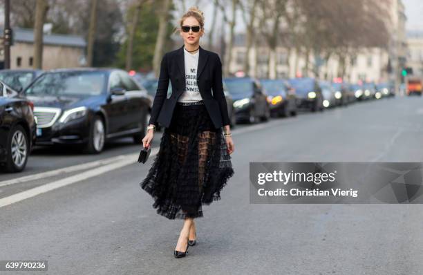 Chiara Ferragni wearing a white Dior tshirt We should all be feminists, black blazer and sheer skirt Dior outside Dior on January 23, 2017 in Paris,...