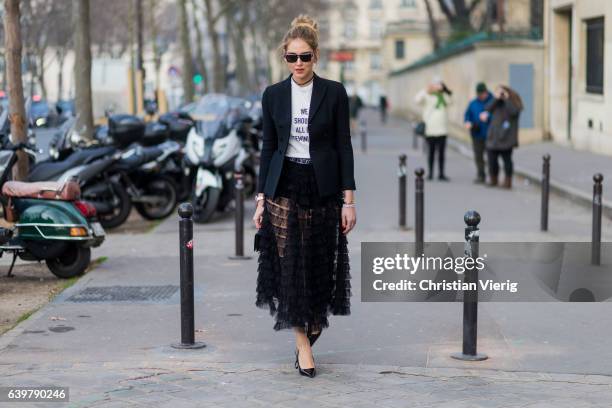 Chiara Ferragni wearing a white Dior tshirt We should all be feminists, black blazer and sheer skirt Dior outside Dior on January 23, 2017 in Paris,...