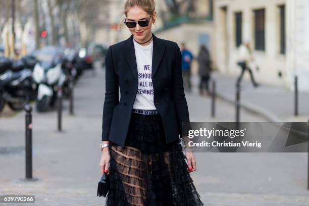 Chiara Ferragni wearing a white Dior tshirt We should all be feminists, black blazer and sheer skirt Dior outside Dior on January 23, 2017 in Paris,...