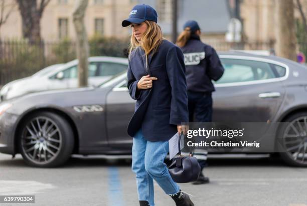 Miroslava Duma wearing a navy jacket, capt and cropped denim jeans outside Dior on January 23, 2017 in Paris, Canada.