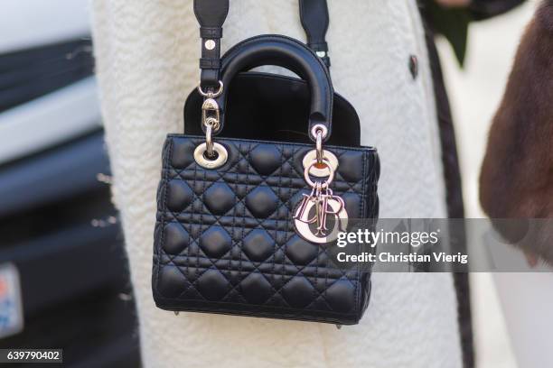 Black Dior bag outside Dior on January 23, 2017 in Paris, Canada.