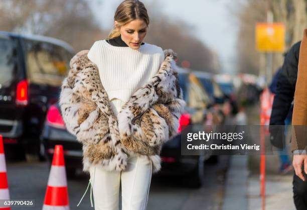 Oliva Palermo wearing a fur jacket and white knit and cropped pants outside Dior on January 23, 2017 in Paris, Canada.