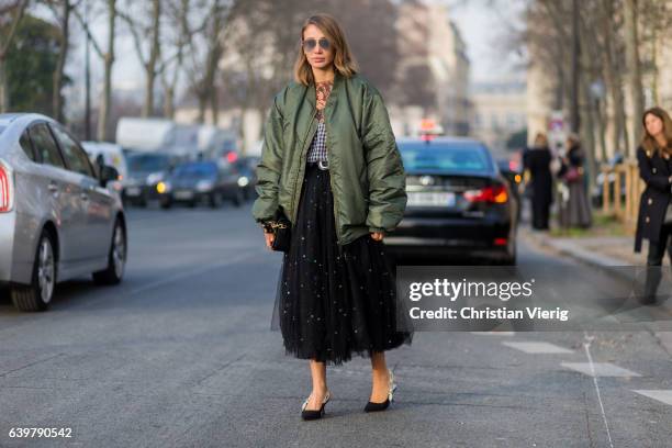 Guest wearing a navy bomber jacket J Adior bag outside Dior on January 23, 2017 in Paris, Canada.